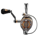 Front view spinning reel with silver magnesium body, gold spool accents and black ergonomic rubber handle knob.