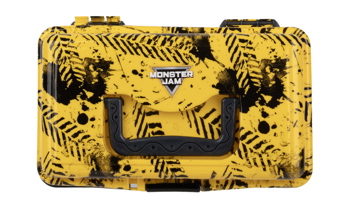 Top view of Monster Jam play box showing yellow case with black tire-tread splatter, Monster Jam logo, black handle and latch