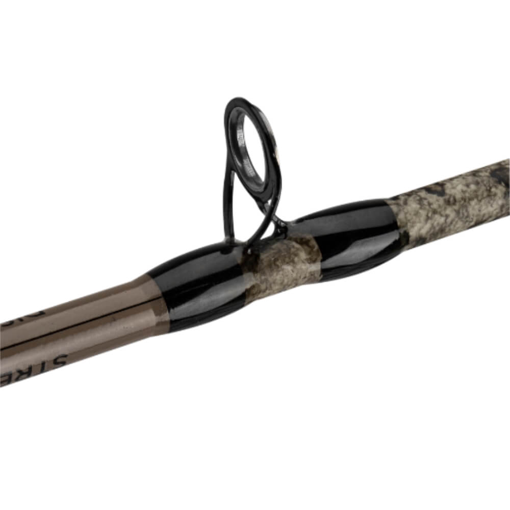 Close-up of spin-cast fishing rod guide and wrapped camo blank.