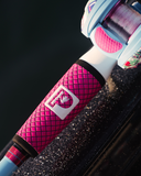 Close-up view of Wild Child Baitcast Combo showcasing hot pink EVA-style grip and light blue reel against a dark background
