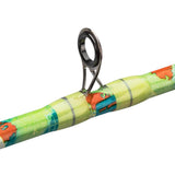 Fishing rod guide loop mounted on a brightly wrapped rod blank, close-up showing metal guide and colorful thread wraps