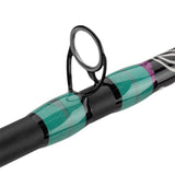 Close up side view of Profishiency Krazy 3 spincast rod guide with black ring and green striped thread wraps on white